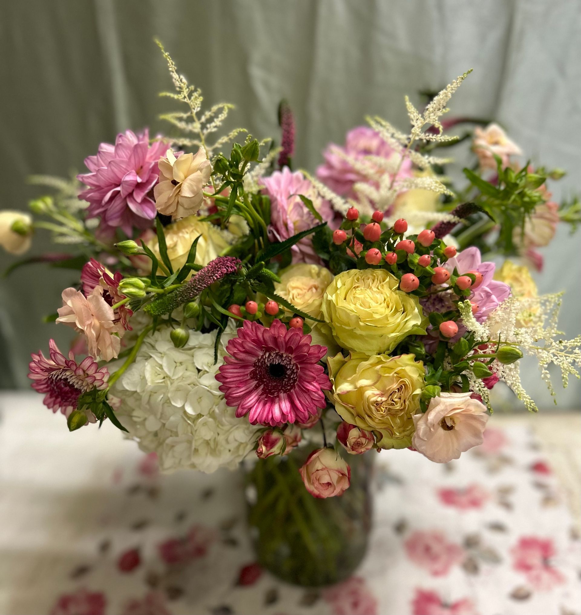 A vase filled with flowers is sitting on a table.