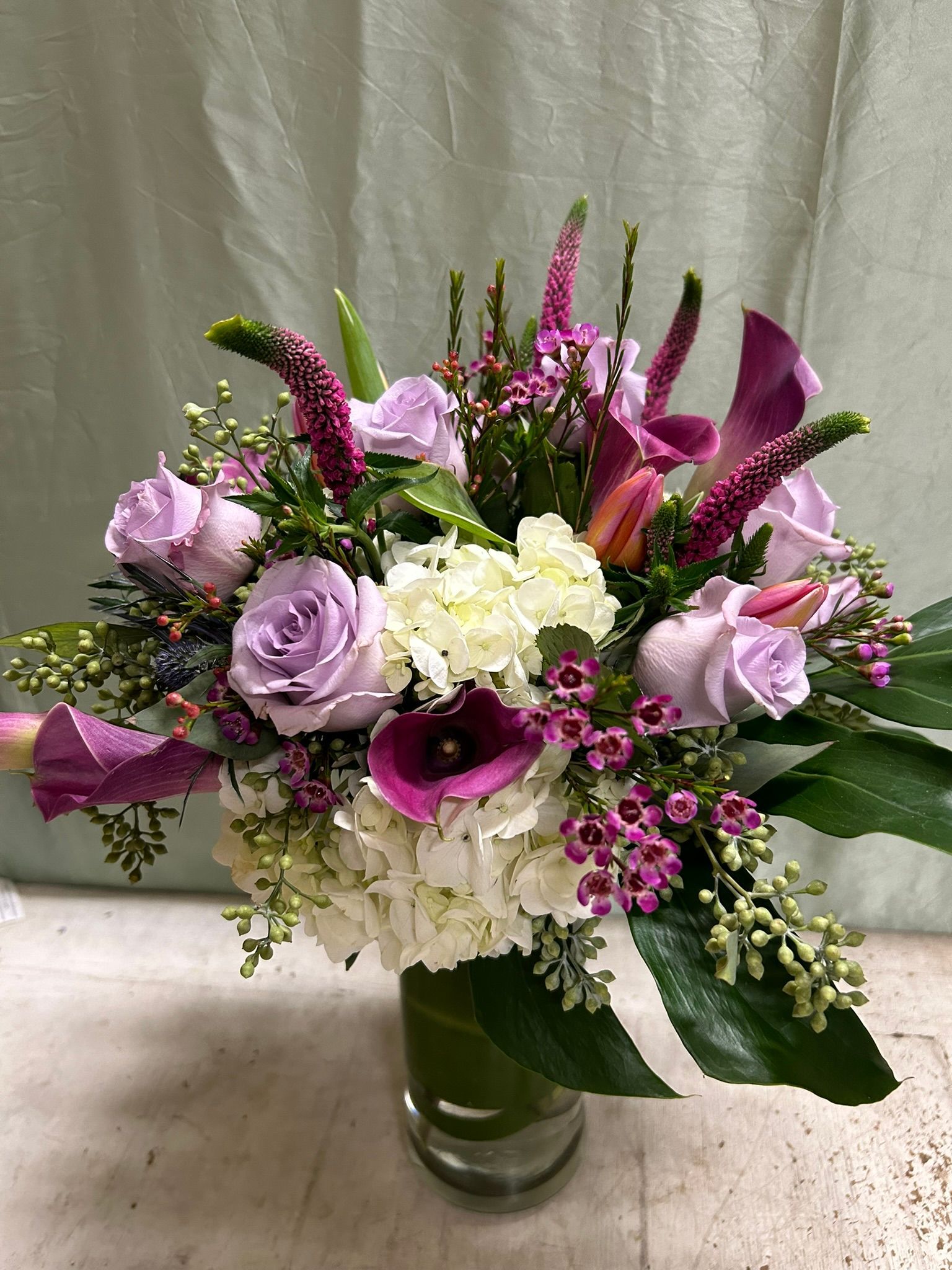 A vase filled with purple and white flowers