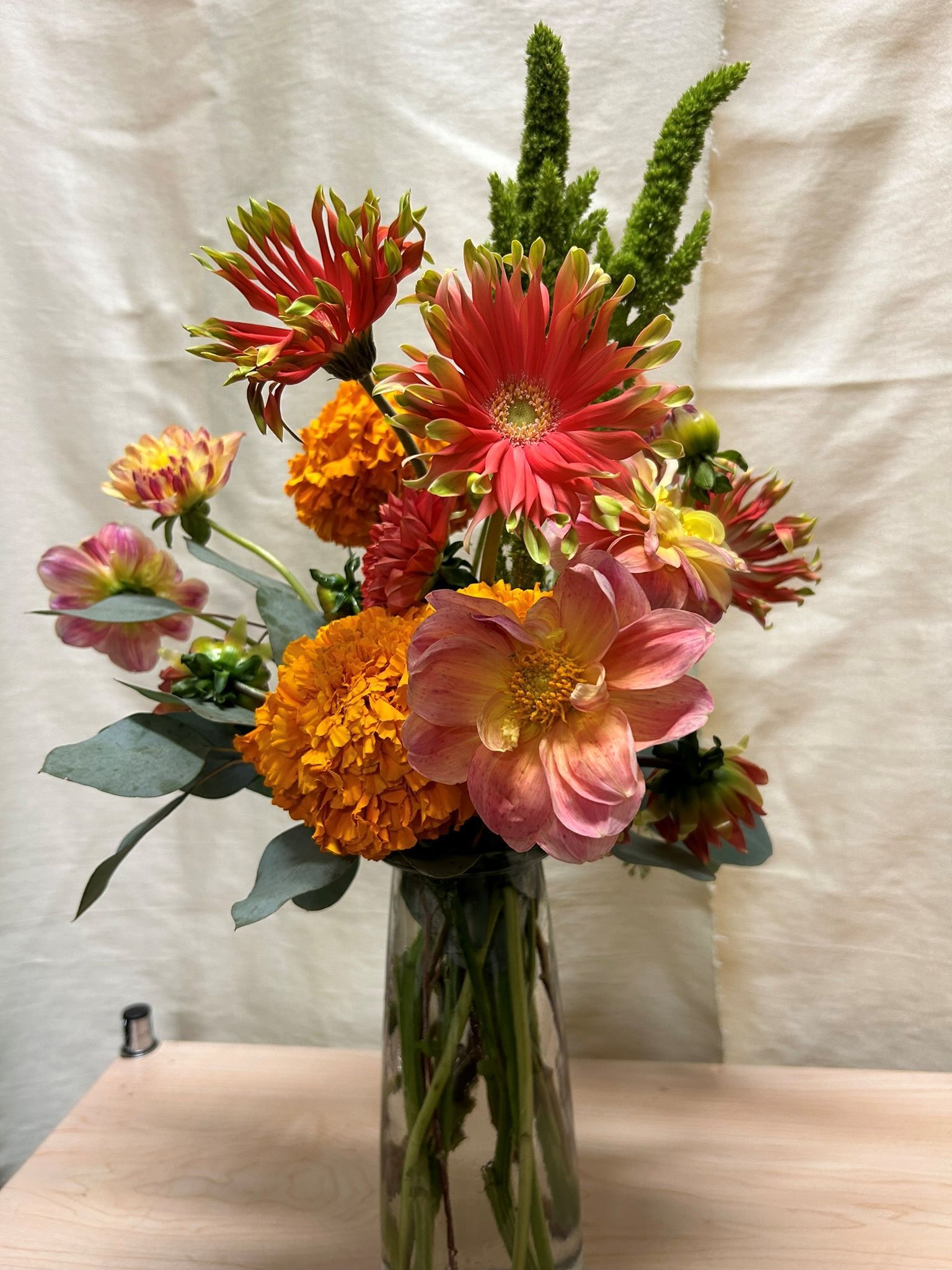 A vase filled with flowers is sitting on a table.