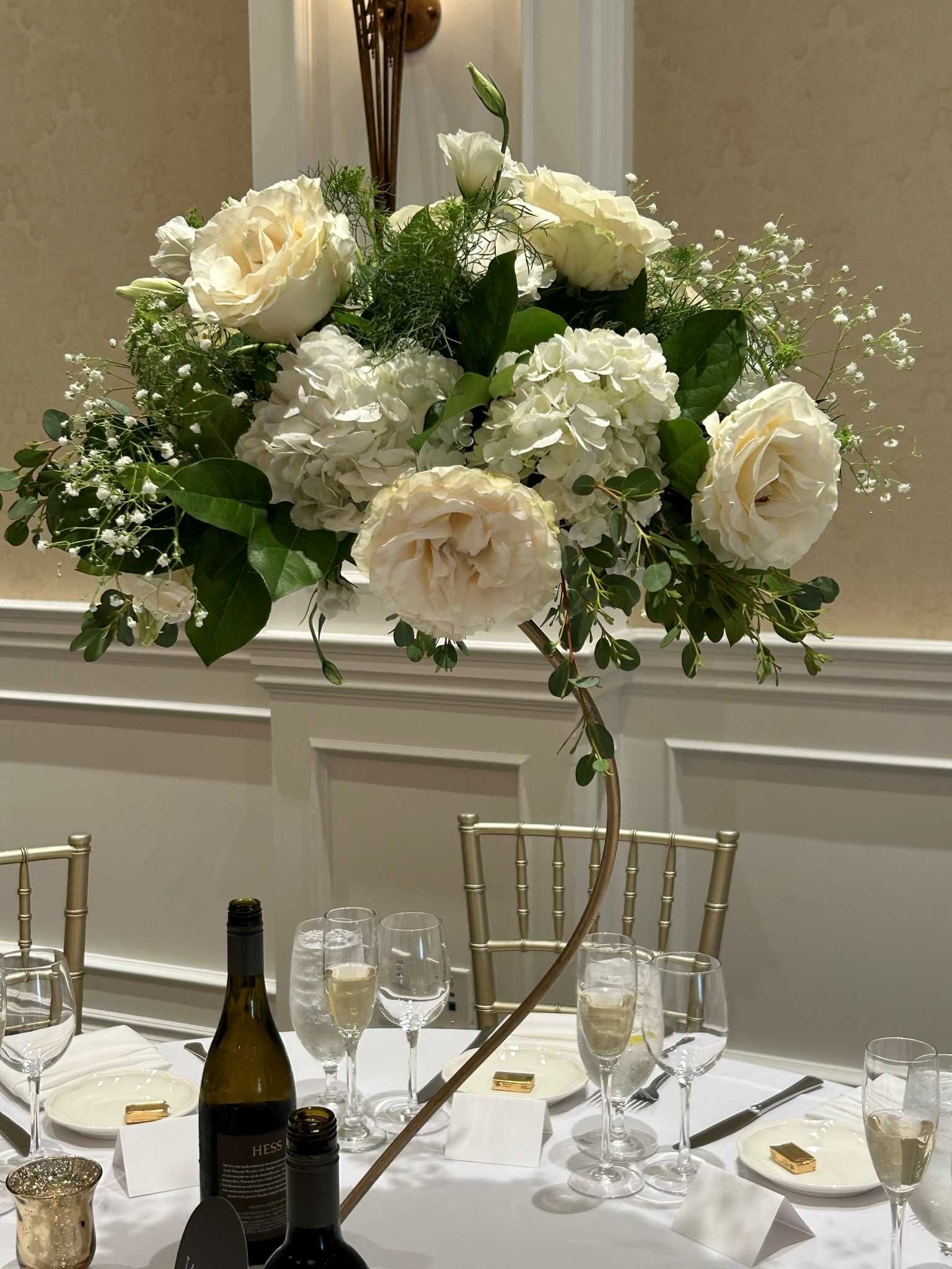 Tall white centerpiece with roses