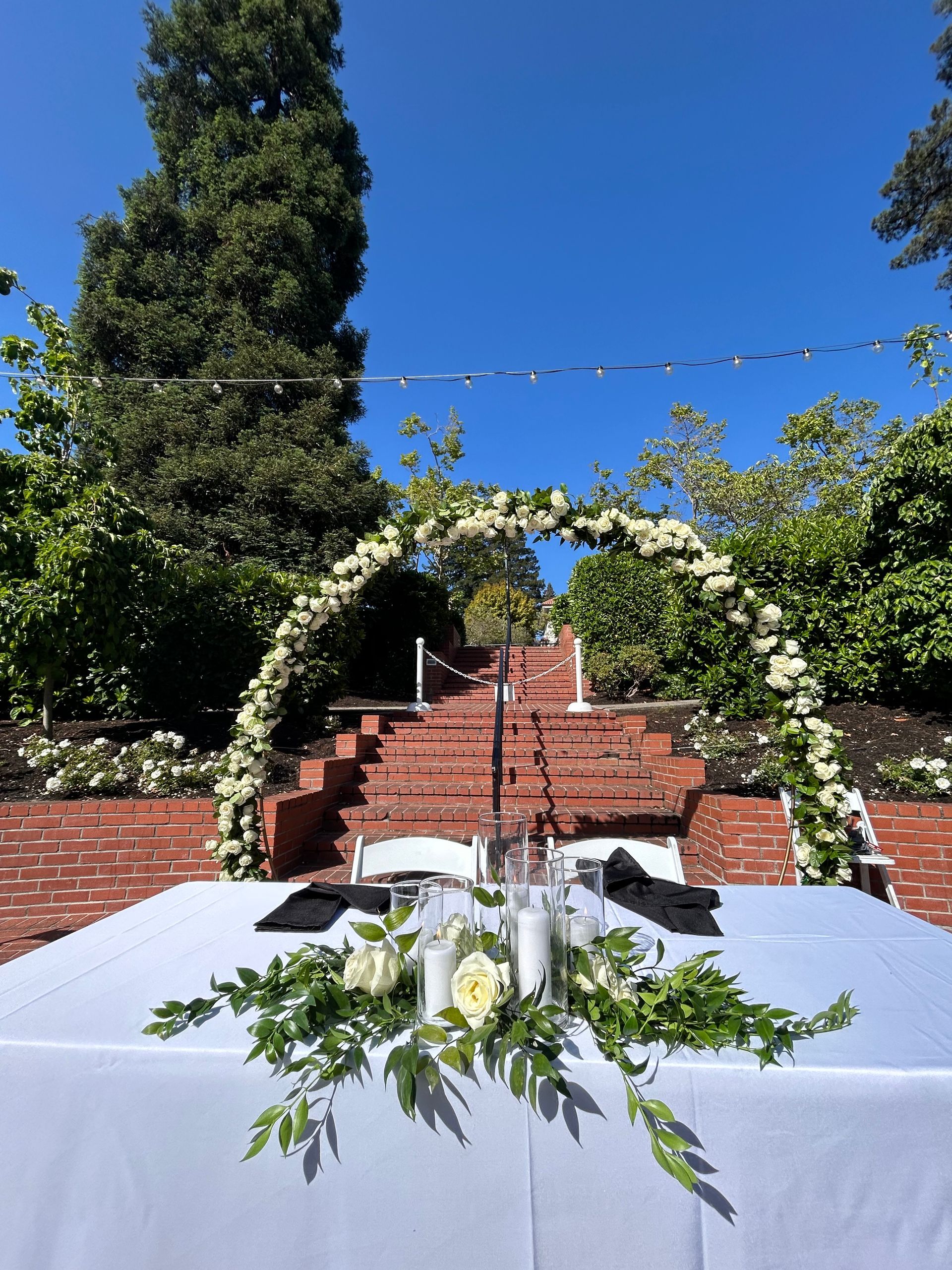 A wedding arch decorated with white roses.