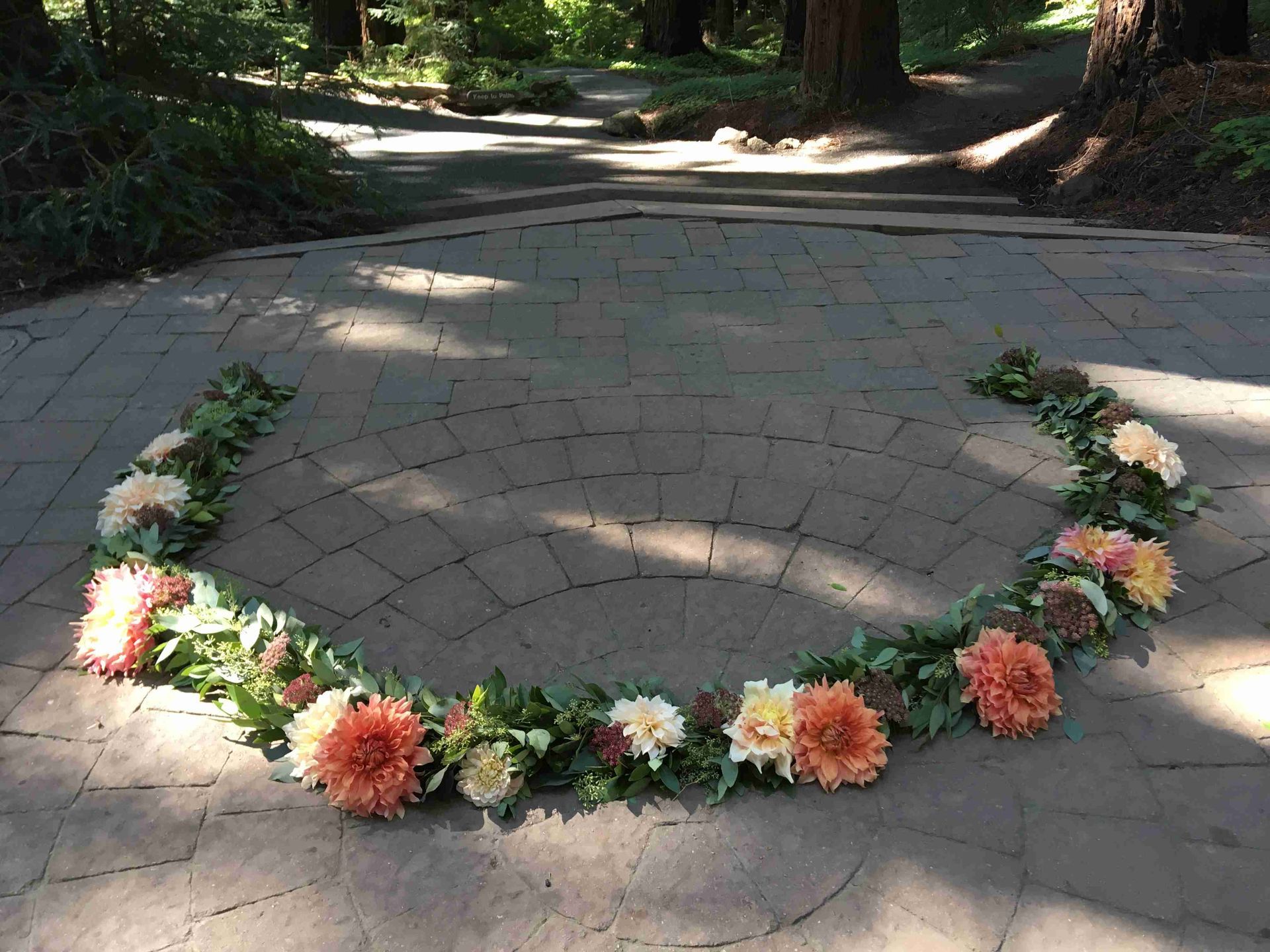 A circle of flowers and leaves for a wedding ceremony.