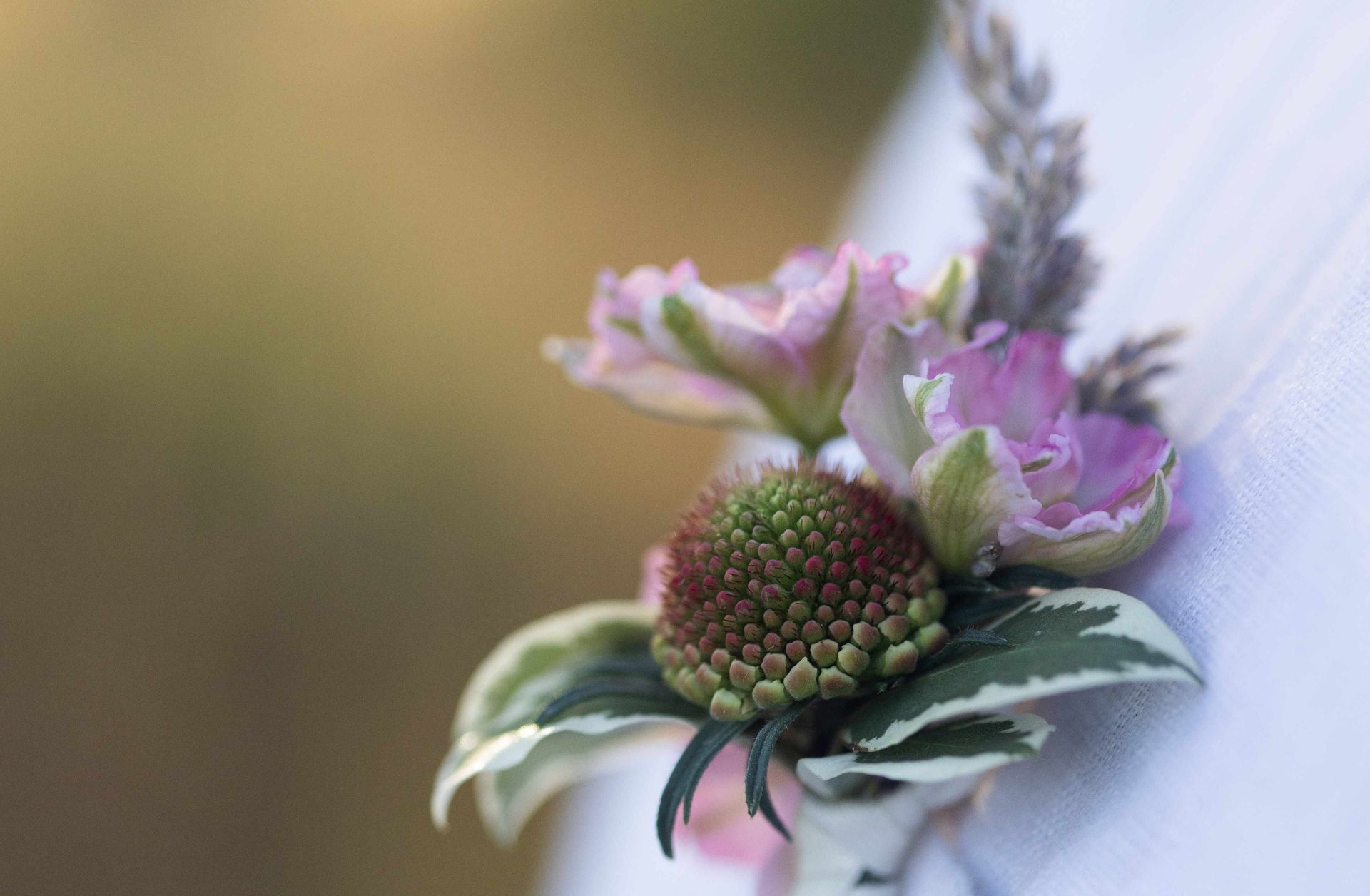 A close up of a flower on a person 's shirt.