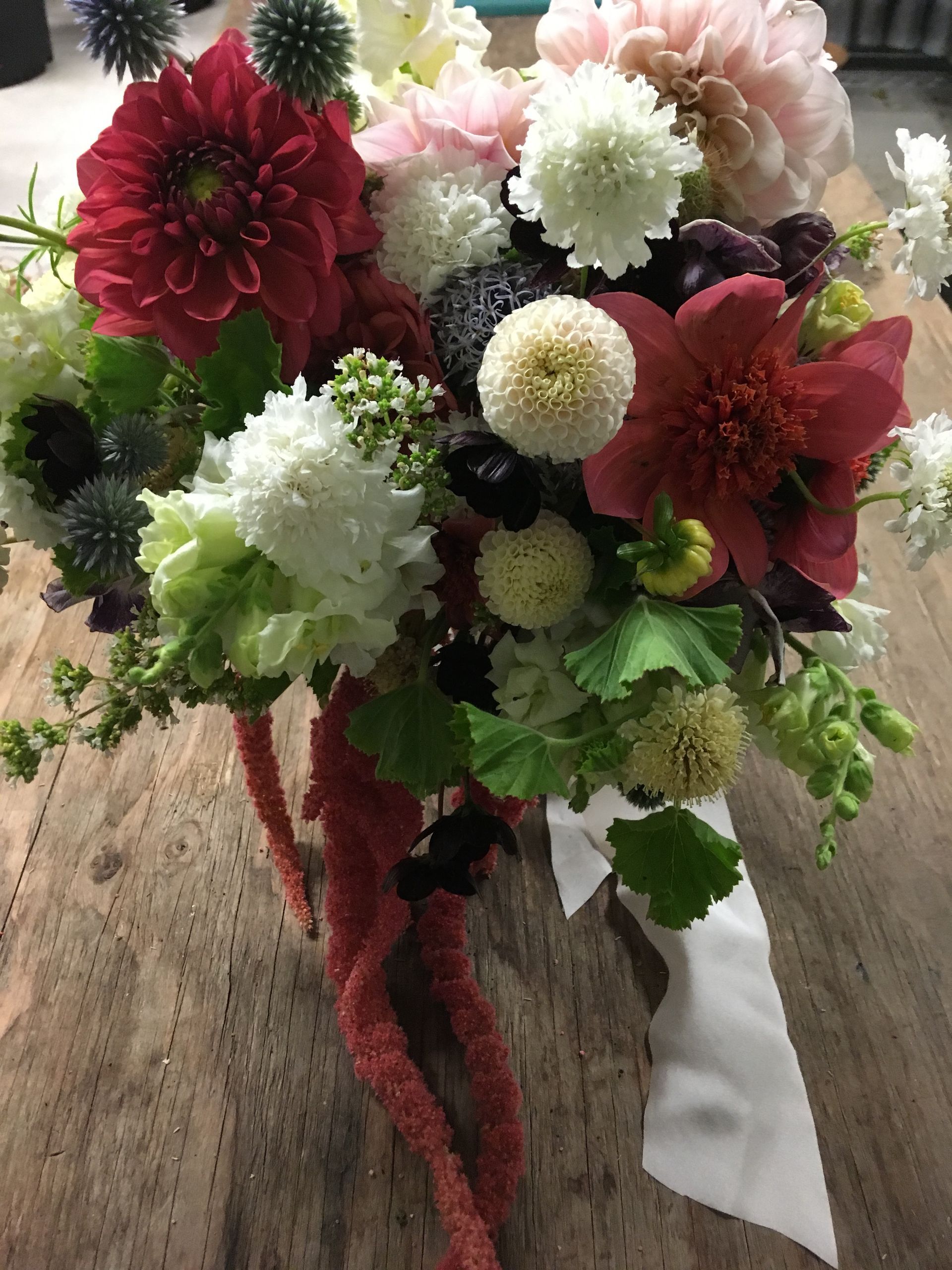 Garden inspired bridal bouquet designed with dahlias, chocolate cosmos, scabiosa and geranium foliage.