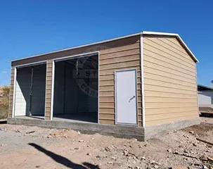 a metal garage with a white door is sitting in the middle of a dirt field
