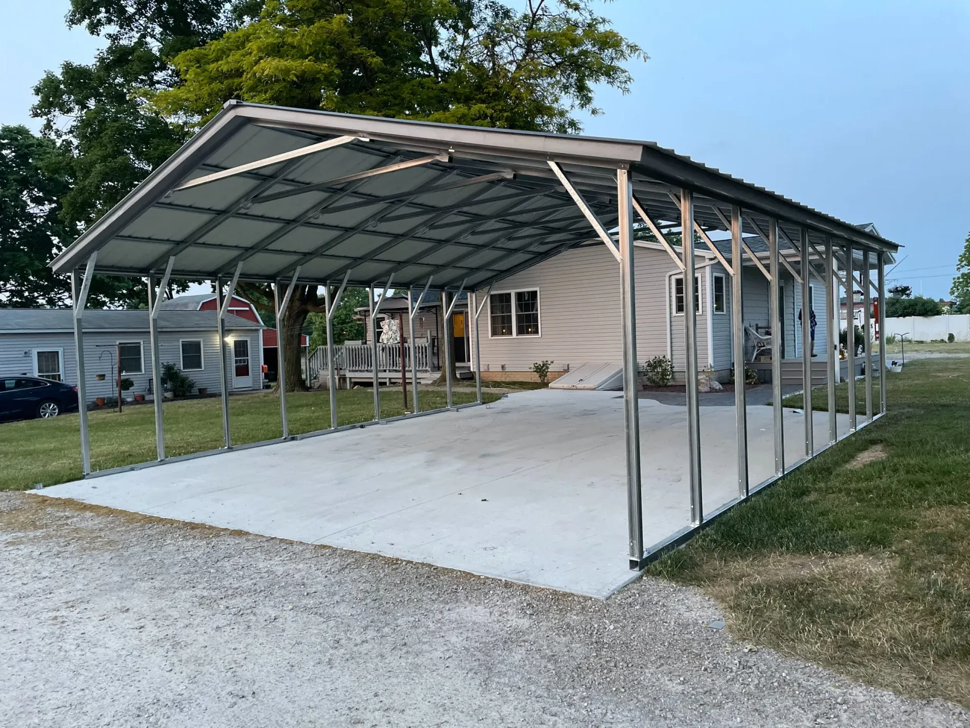 a metal carport is sitting in front of a house