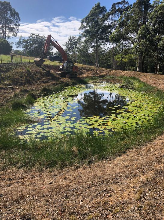 A Large Swimming Pool Is Sitting In Front Of A House — Arnway Pty Ltd In Kempsey, NSW