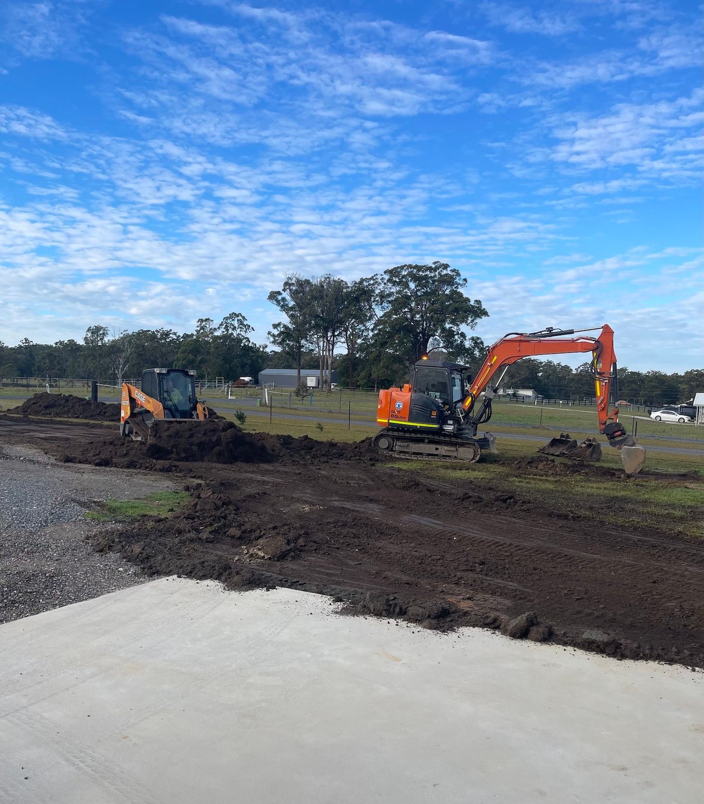 Two Orange Excavators Working On A Construction Site — Arnway Pty Ltd In Wauchope, NSW