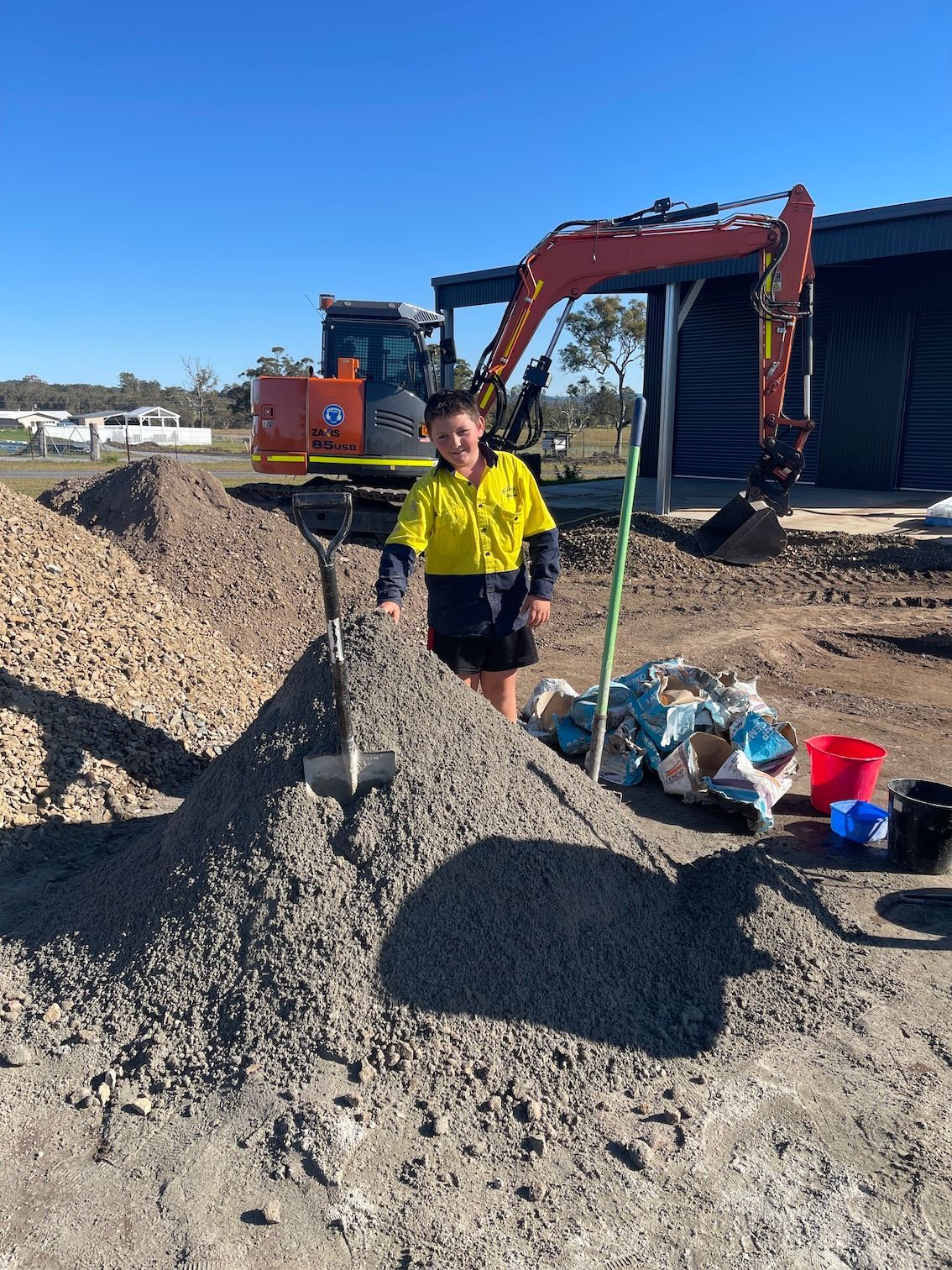 Excavator, Young Child, And A Pile Of Gravel — Arnway Pty Ltd In Kempsey, NSW 