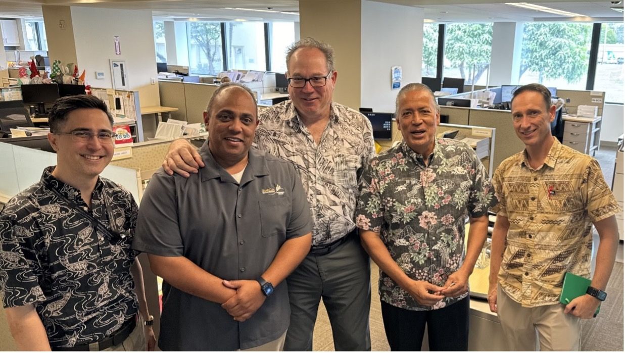 SharCon GS and GSI Hawaii are posing for a picture in an office.