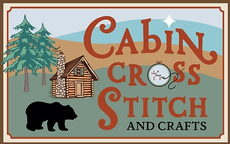 Cabin Cross Stitch and Crafts logo with cabin, trees, bear, and mountains on tan background