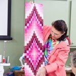 Woman holding her work — Authorized Dealer in Pensacola FL