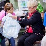 Woman Giving her Gift — Authorized Dealer in Pensacola FL