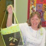 Woman Holding Green Black Toned Bag — Authorized Dealer in Pensacola FL