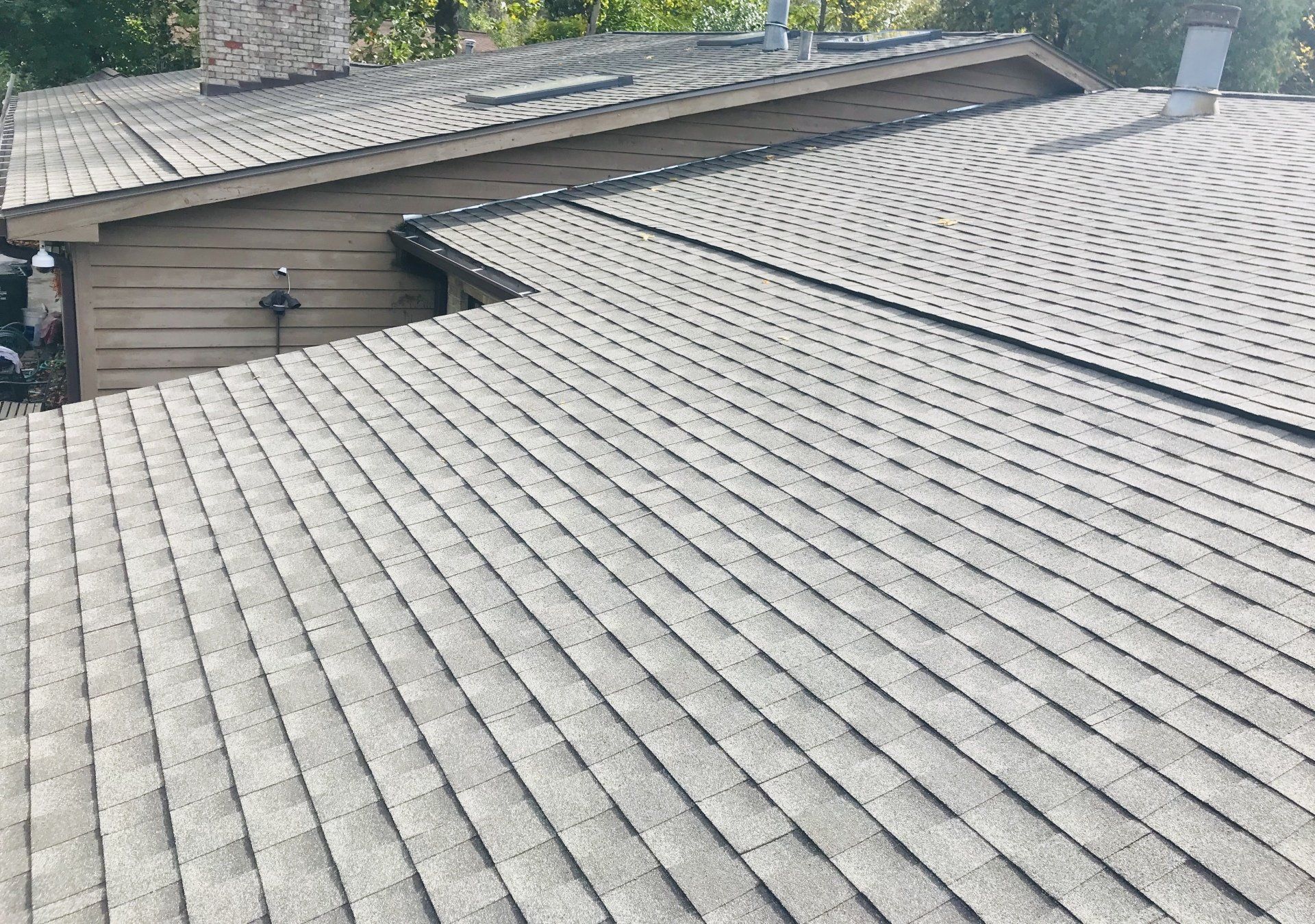A close up of a roof of a house with shingles on it.