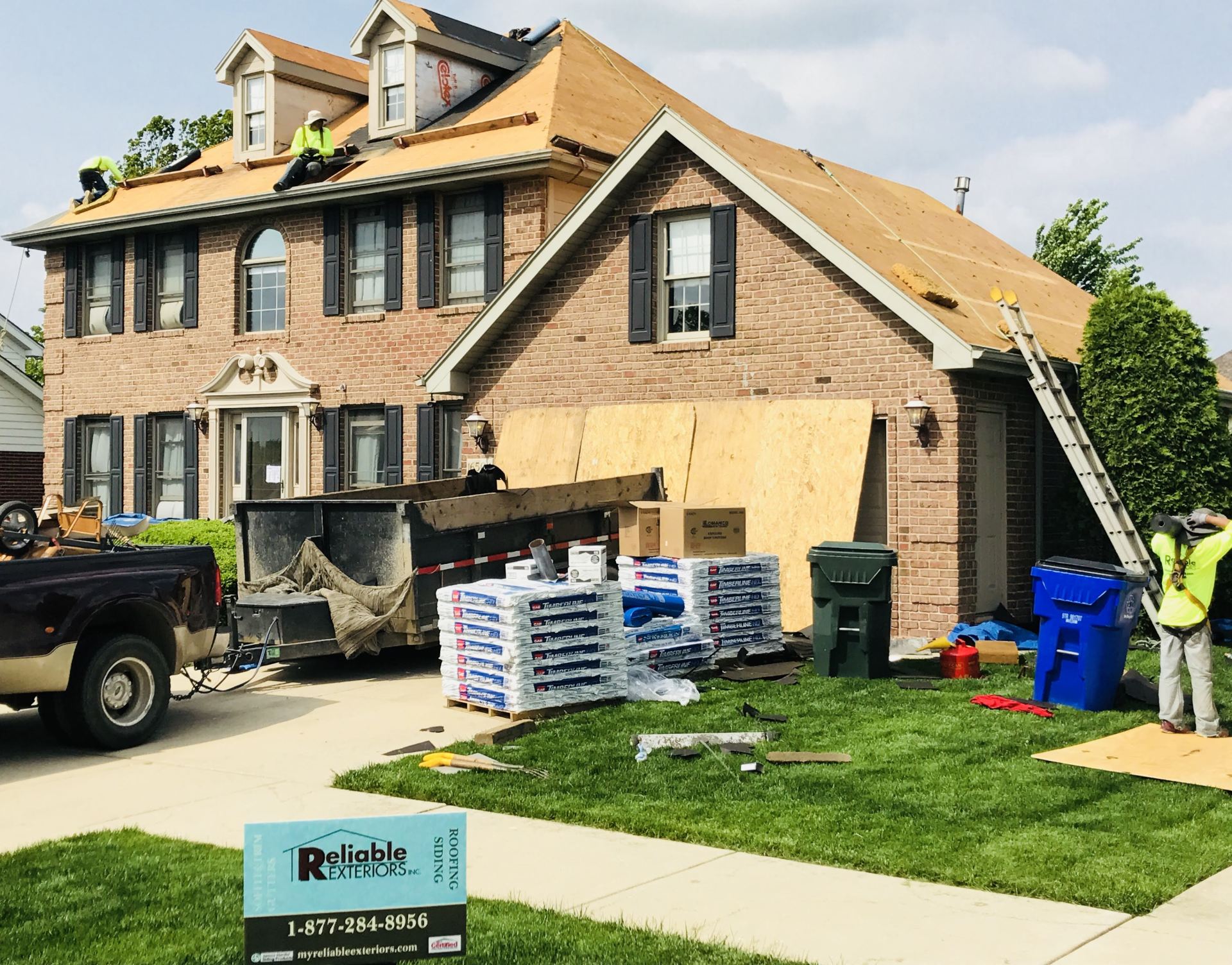 A truck is parked in front of a house that is being remodeled.