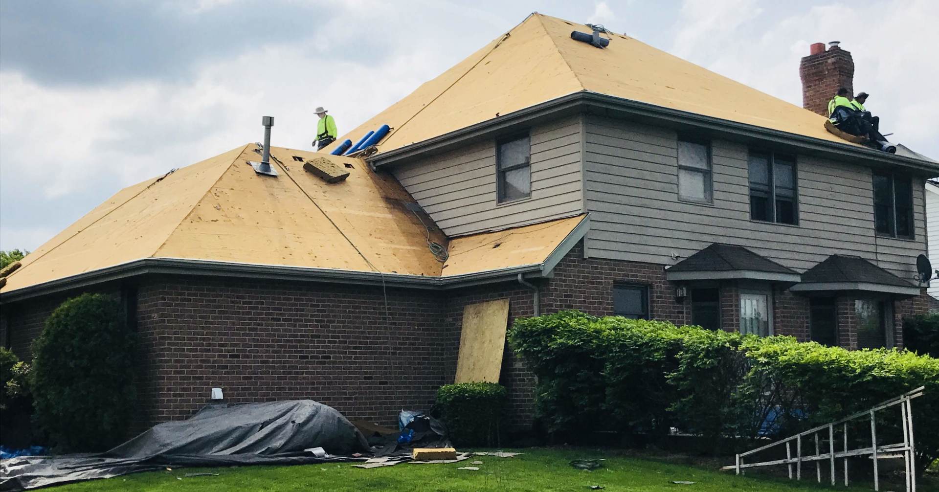A house is being remodeled with a new roof being installed.