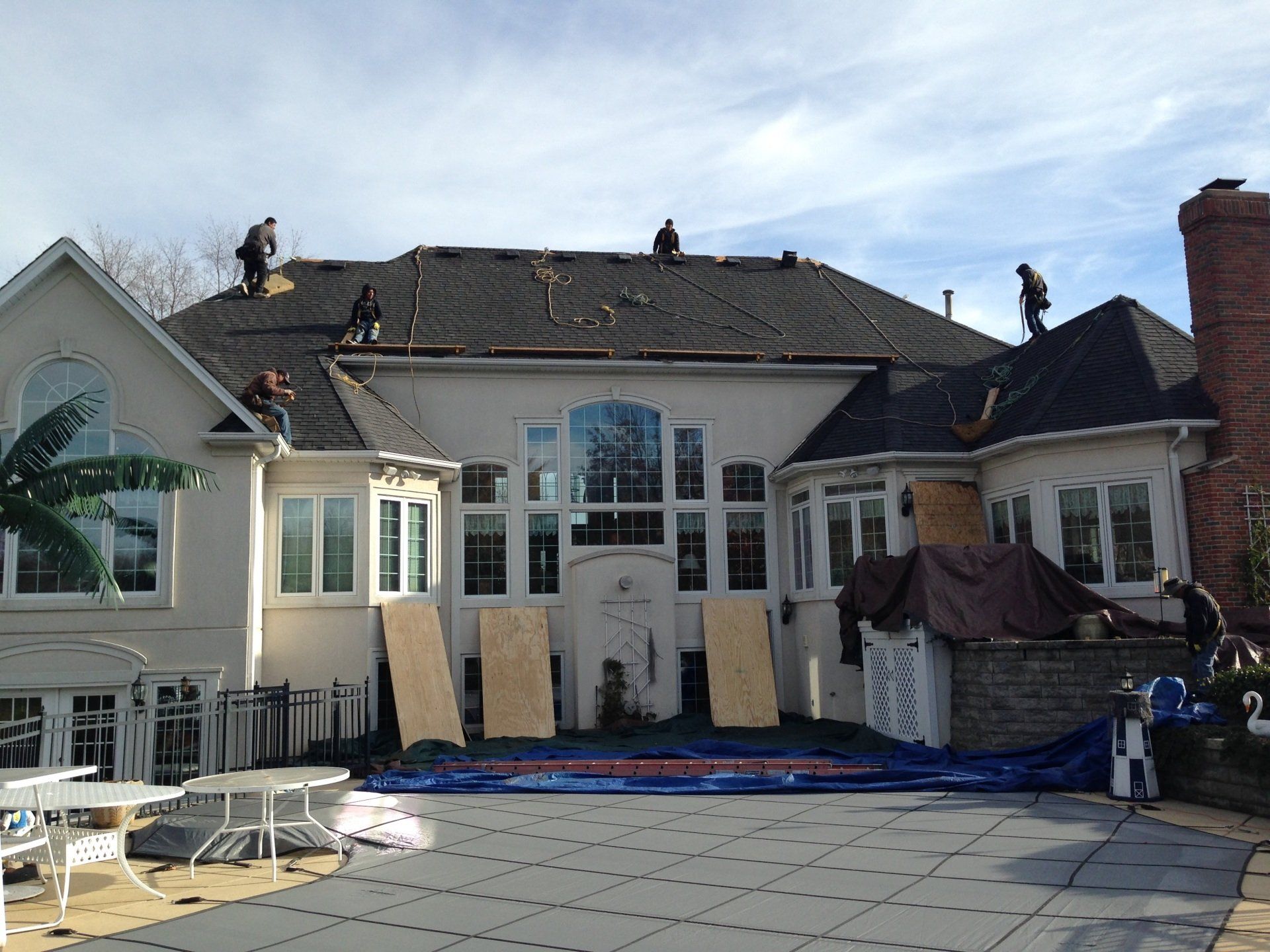 A large house with a lot of windows is being remodeled