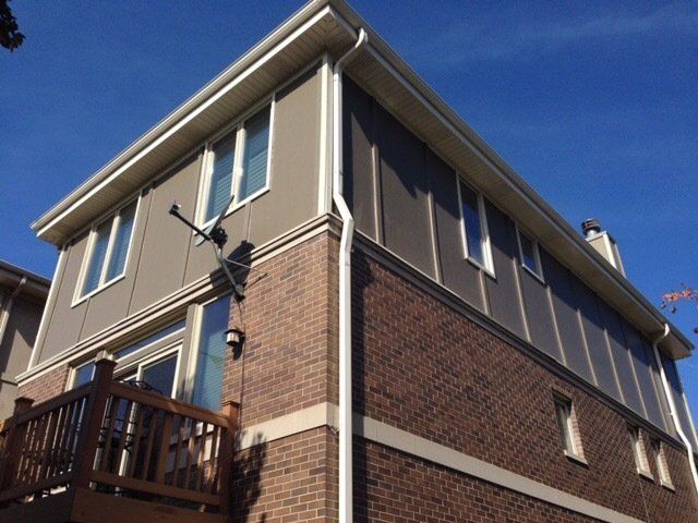 A brick house with a balcony on the side