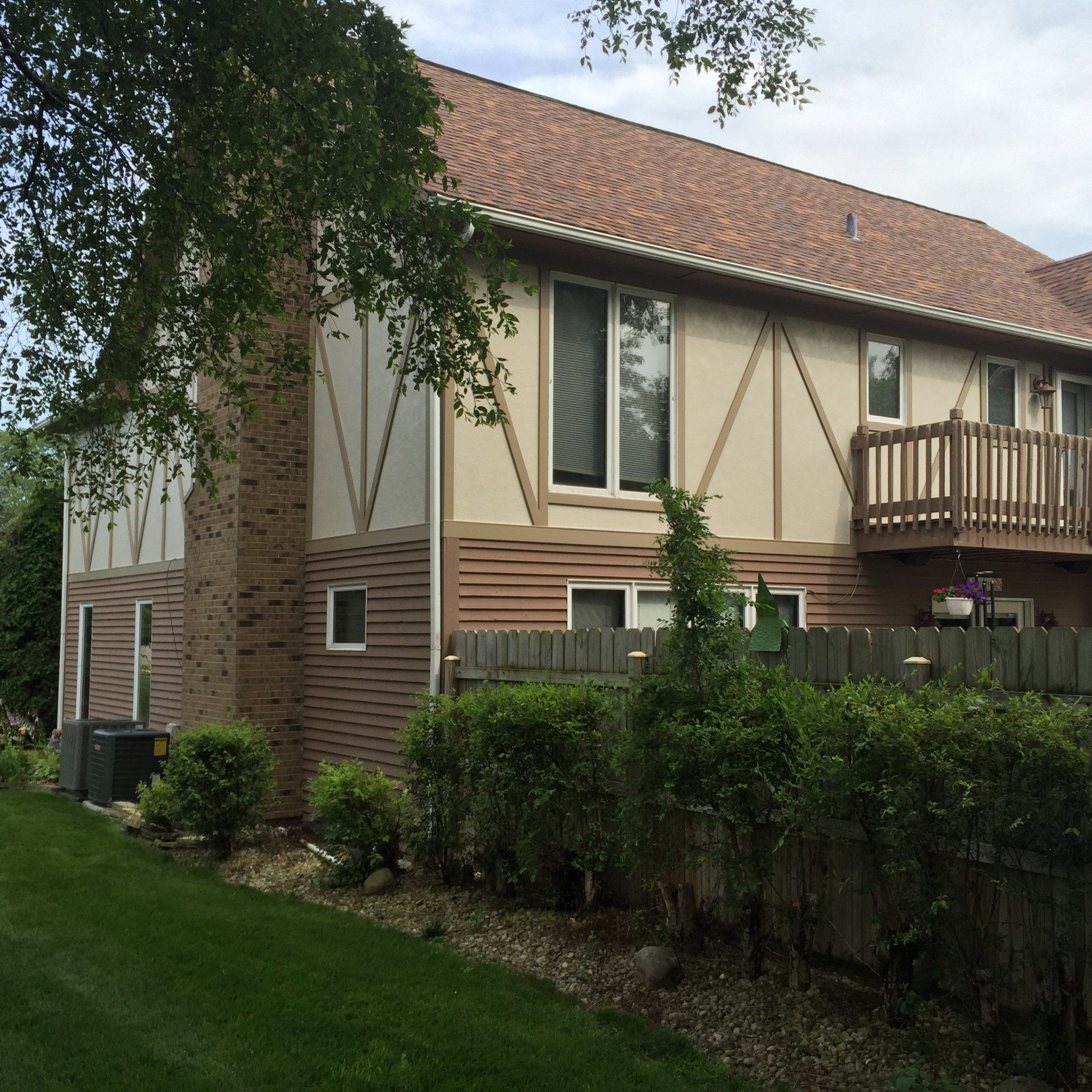 A house with a balcony and a fence around it