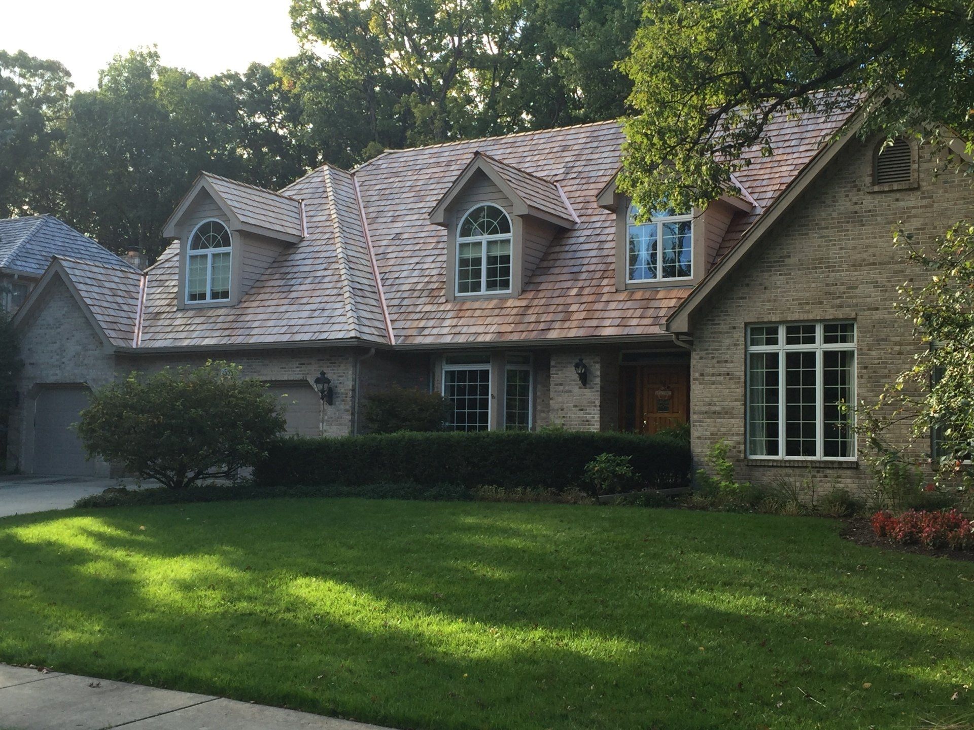 A large brick house with a copper roof