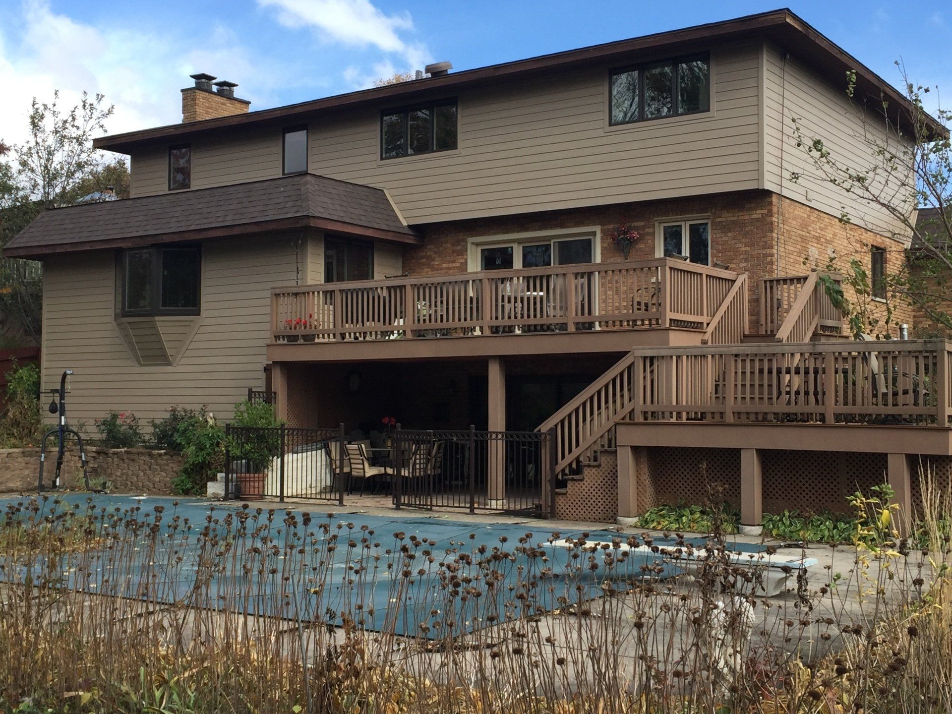 A large house with a swimming pool in front of it
