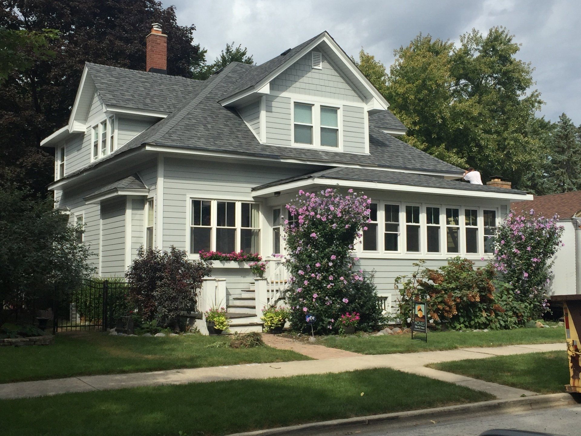 A large white house with a gray roof and many windows