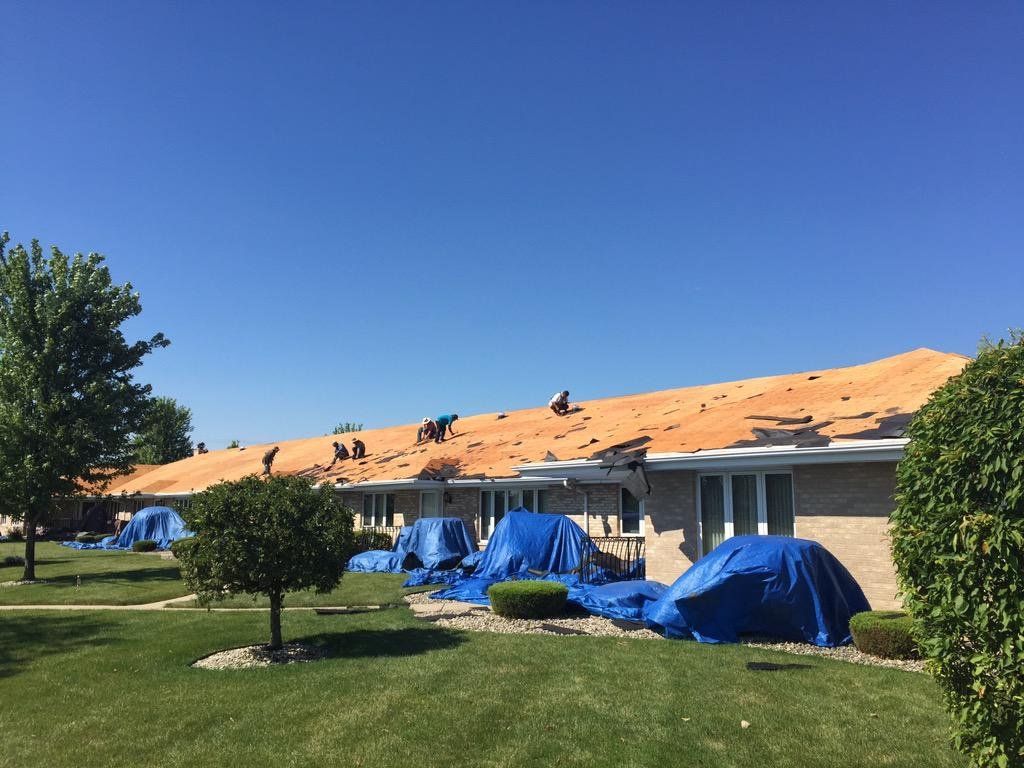 A roof is being installed on a house in a residential area.