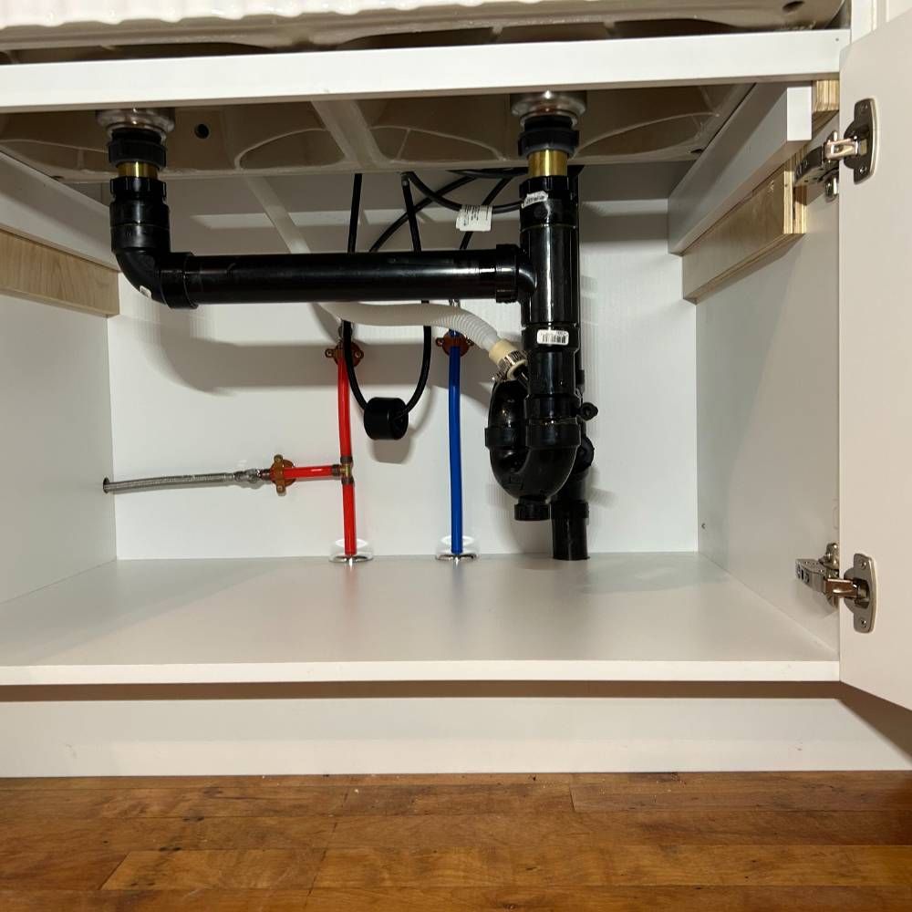 the inside of a cabinet with a sink underneath it