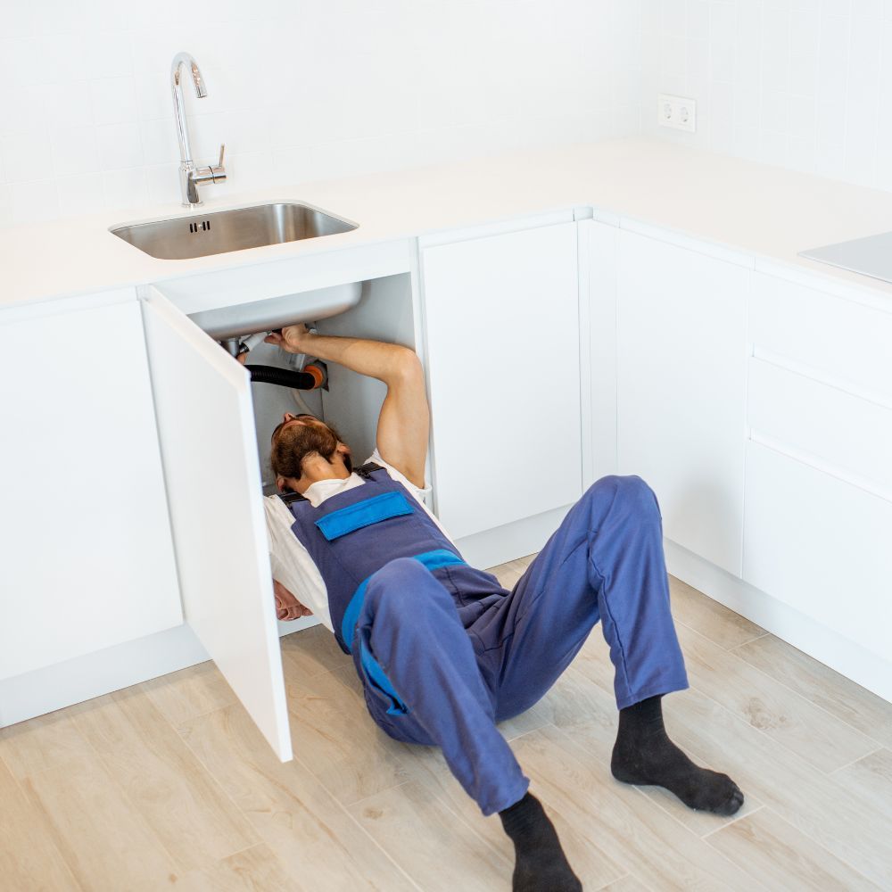 plumber fixing a sink
