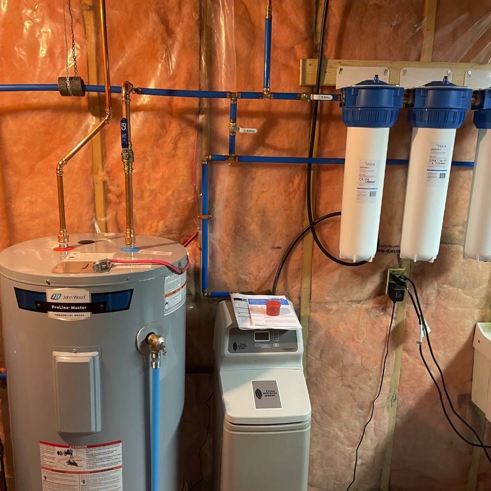 a water heater is sitting in a room next to a water softener .