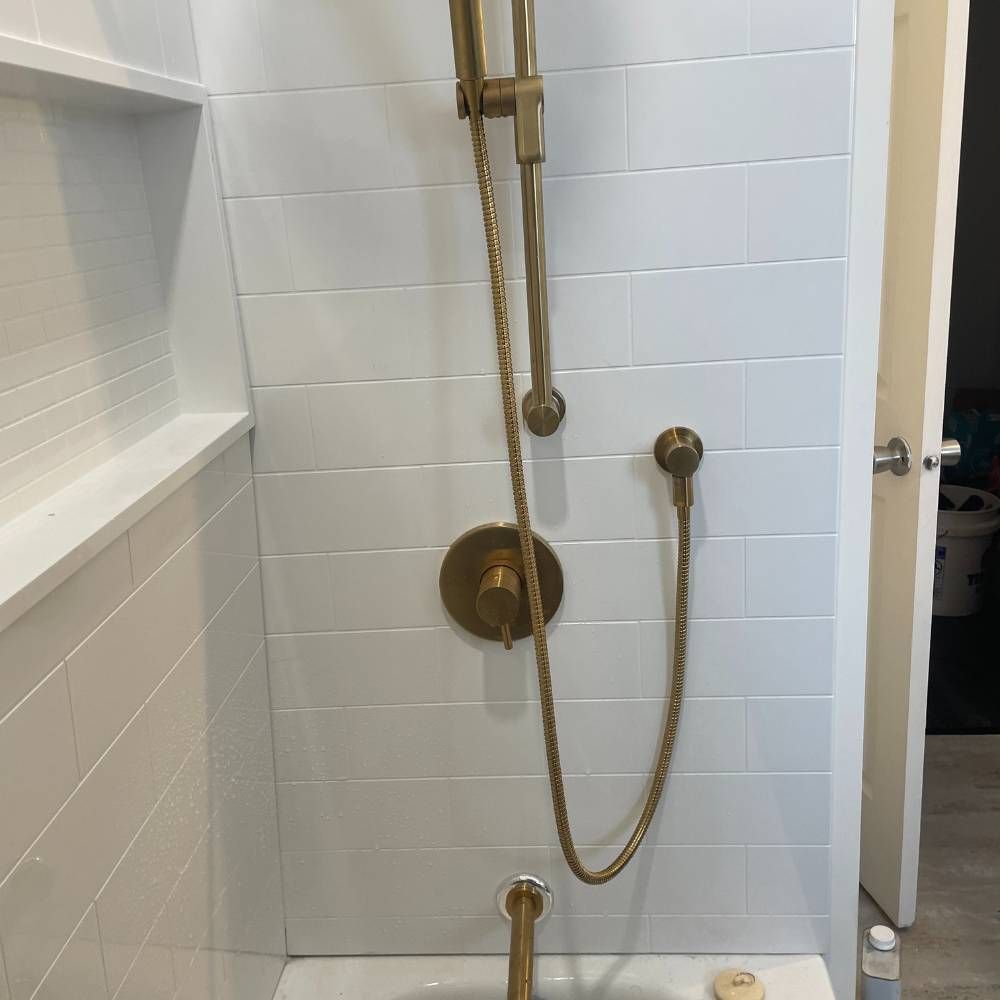 a bathroom with a bathtub and a shower head .
