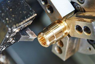 A close up of a machine cutting a piece of metal.