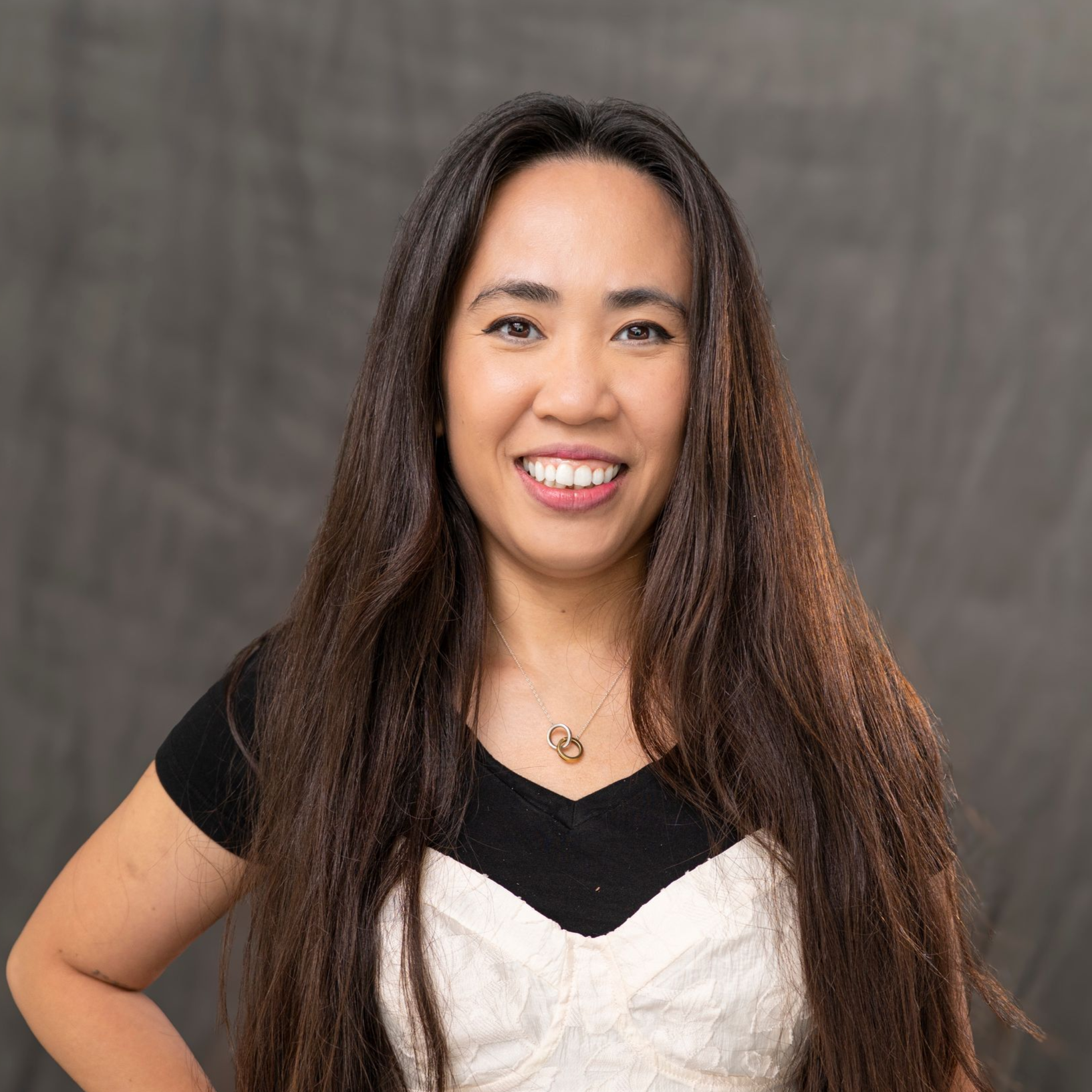 a man in a suit and tie is standing in front of a white car .