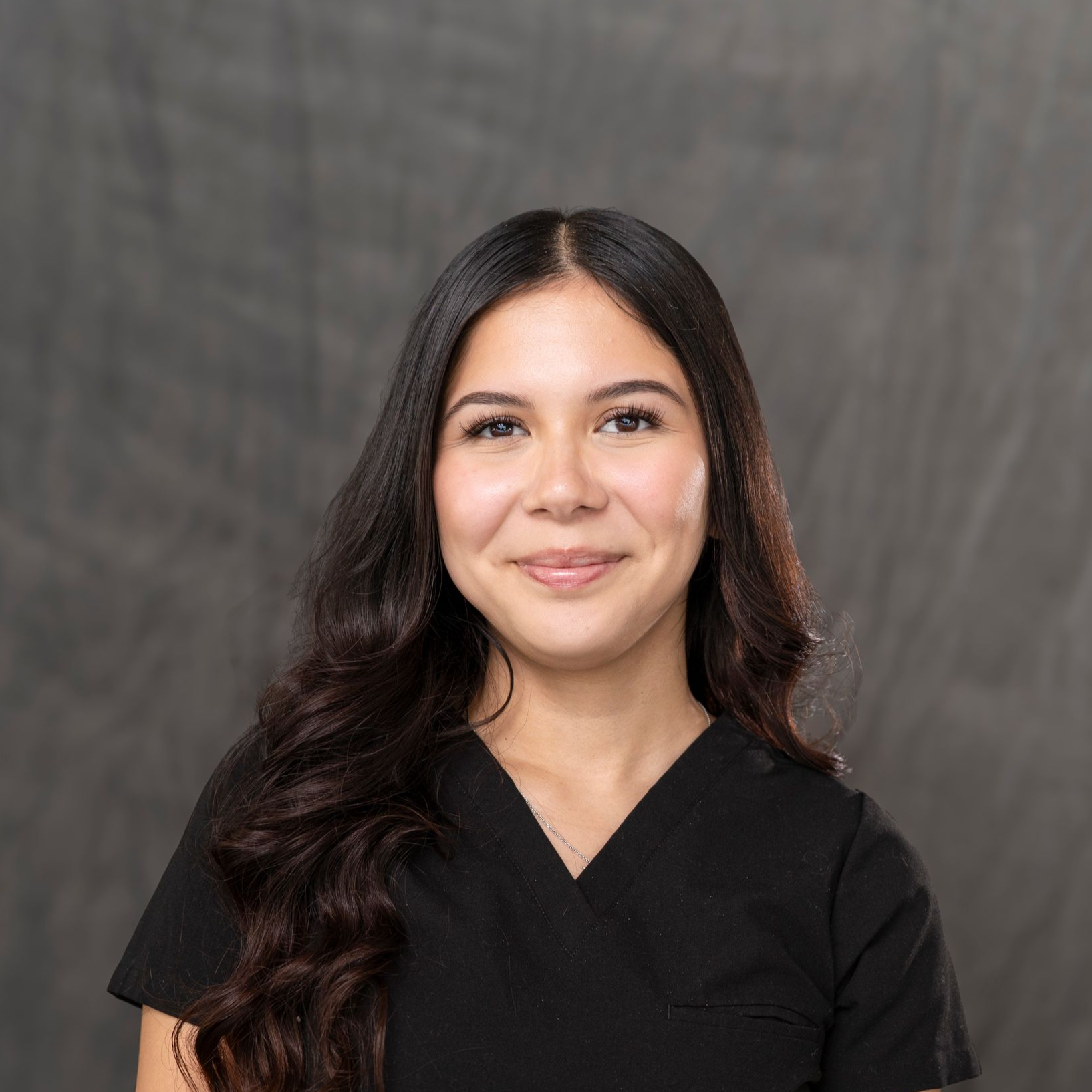 a man in a suit and tie is standing in front of a white car .