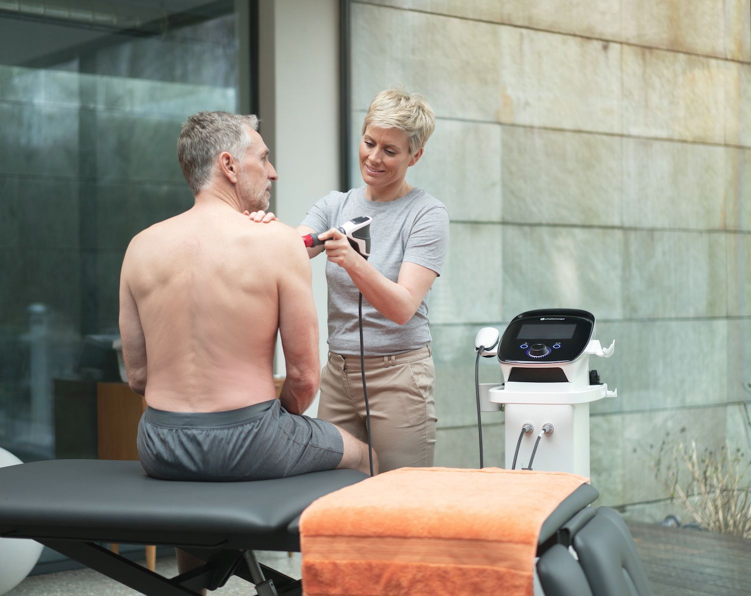 A woman is giving a man a massage on his back.