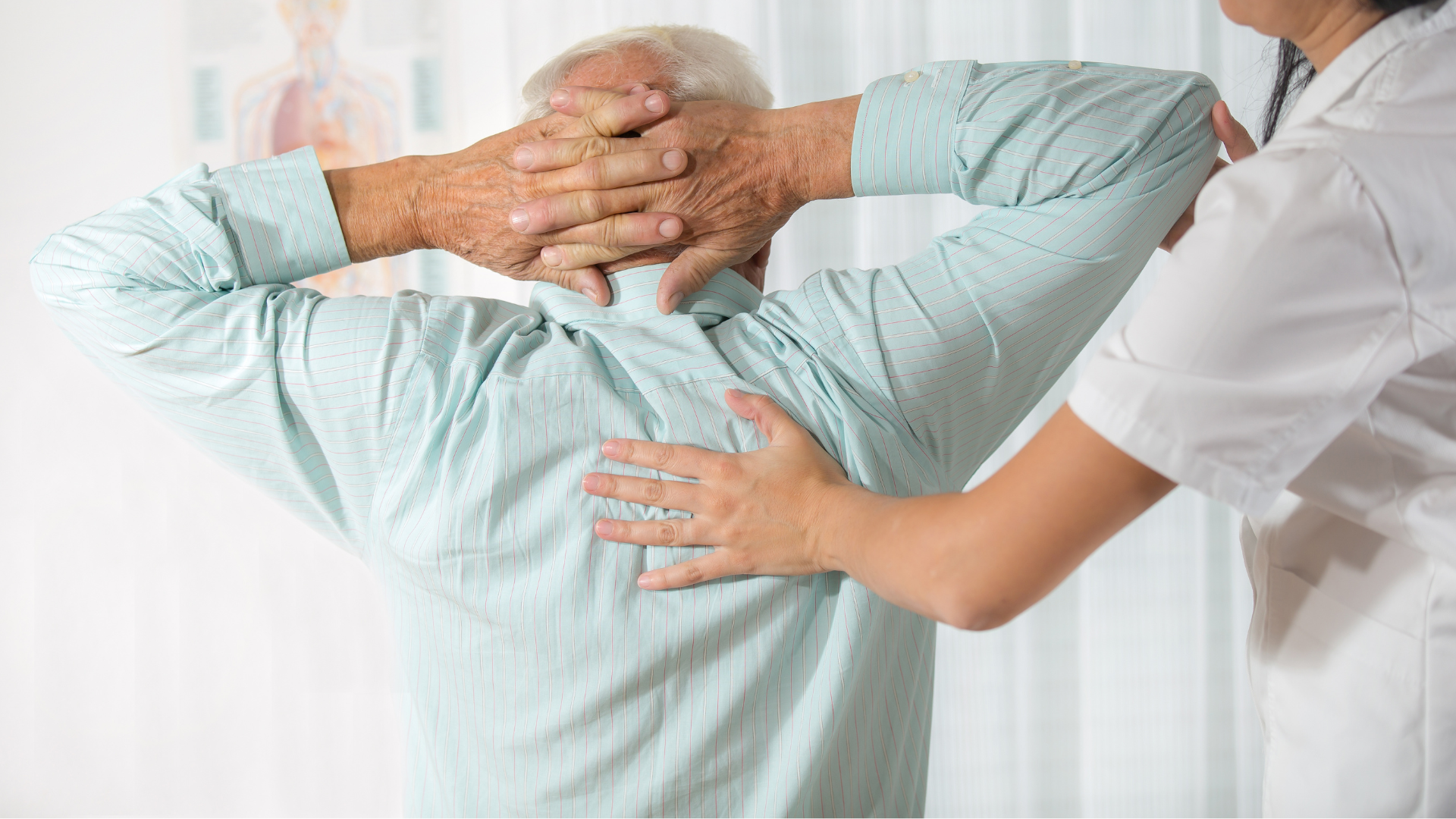 a nurse is helping an elderly man stretch his arms and back .