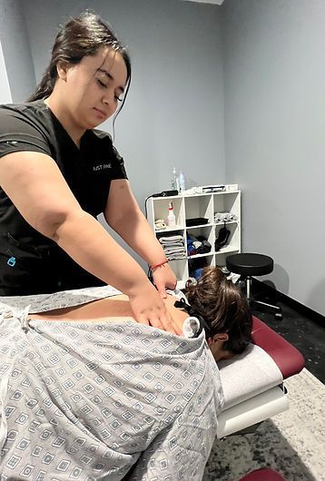 a woman is giving a massage to a patient on a table .