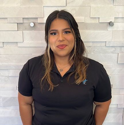 a woman wearing a black scrub top that says just spine