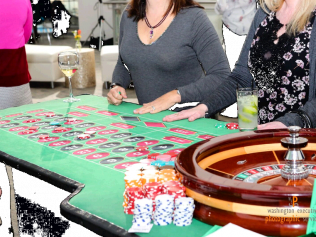 A woman is sitting at a table playing roulette
