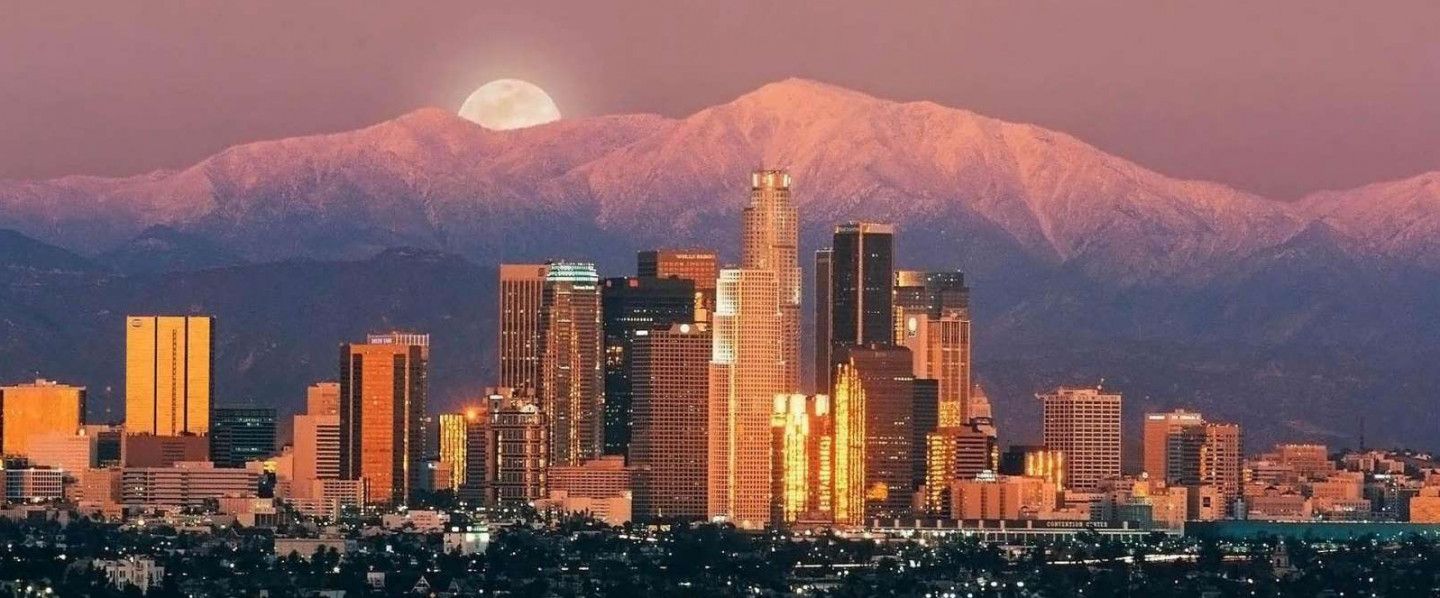 A city skyline with a mountain in the background