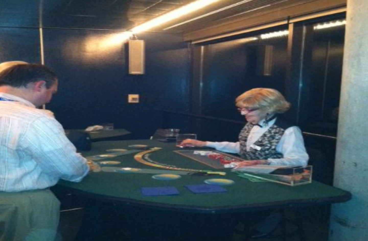 A man and a woman are playing a game of blackjack