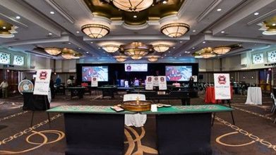 A large room with a table with a roulette wheel on it.