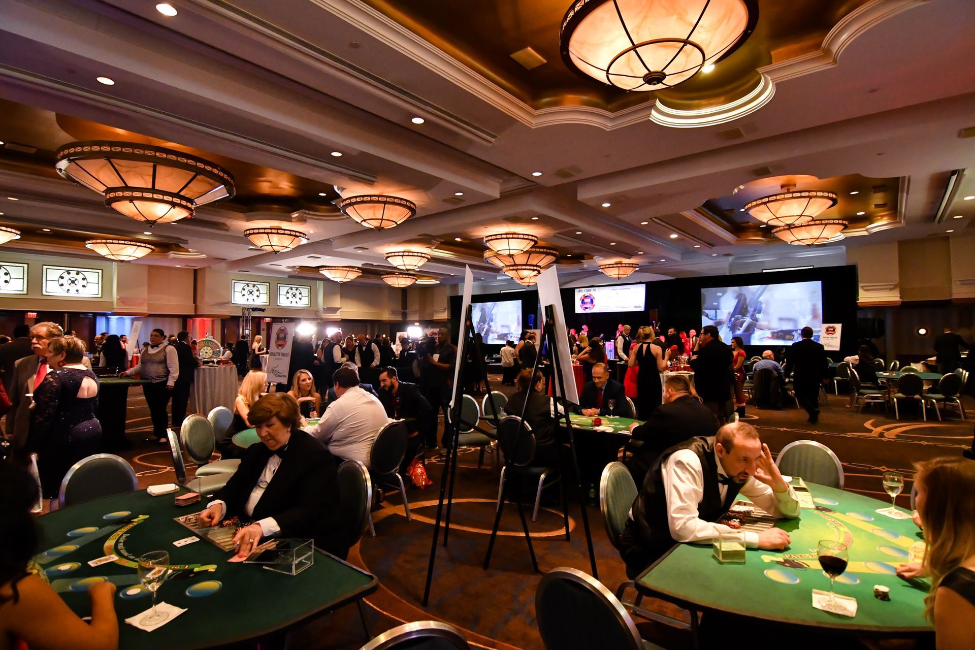 A group of people are playing poker in a casino.