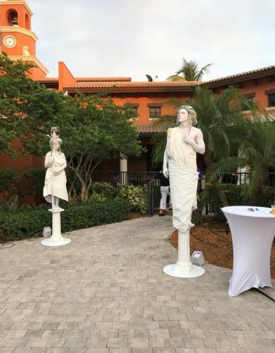 A statue of a woman standing next to a statue of a man