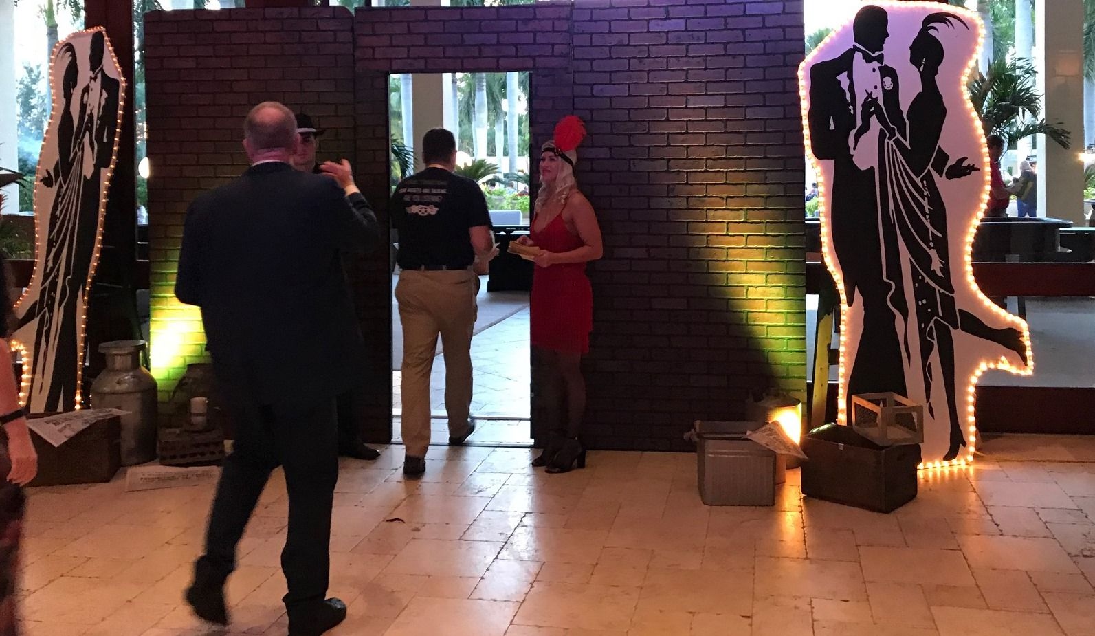 A man is taking a picture of a woman in a red dress