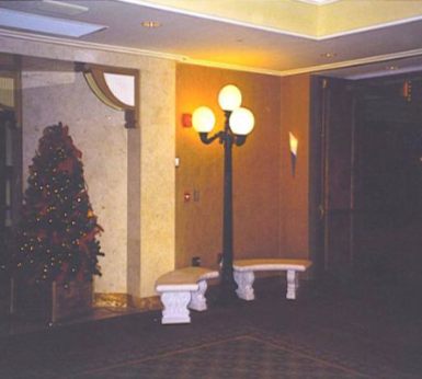 A hallway with a christmas tree and a lamp post