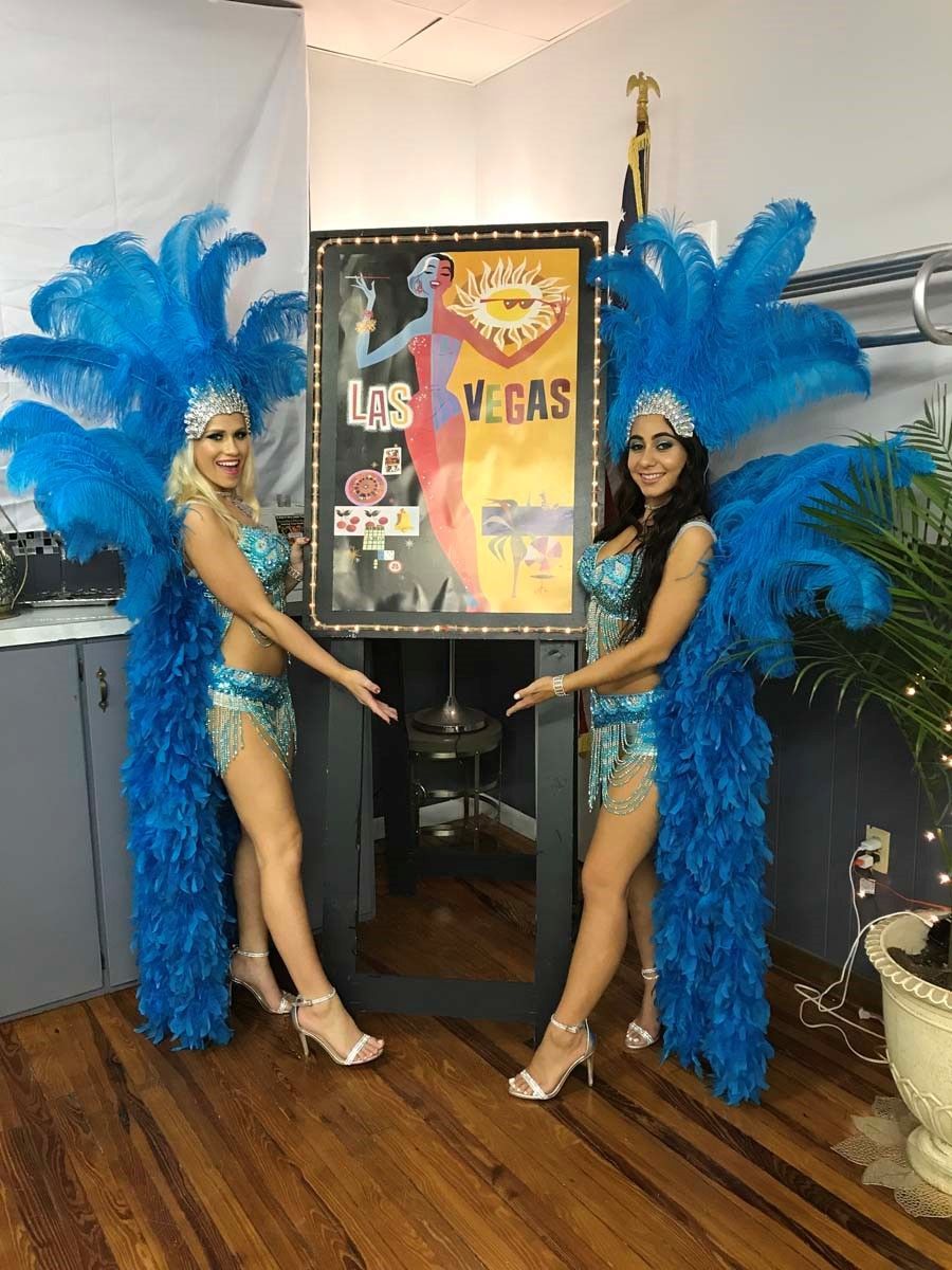 two show girls pointing to a sign