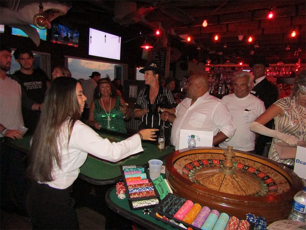 A group of people are playing roulette in a casino