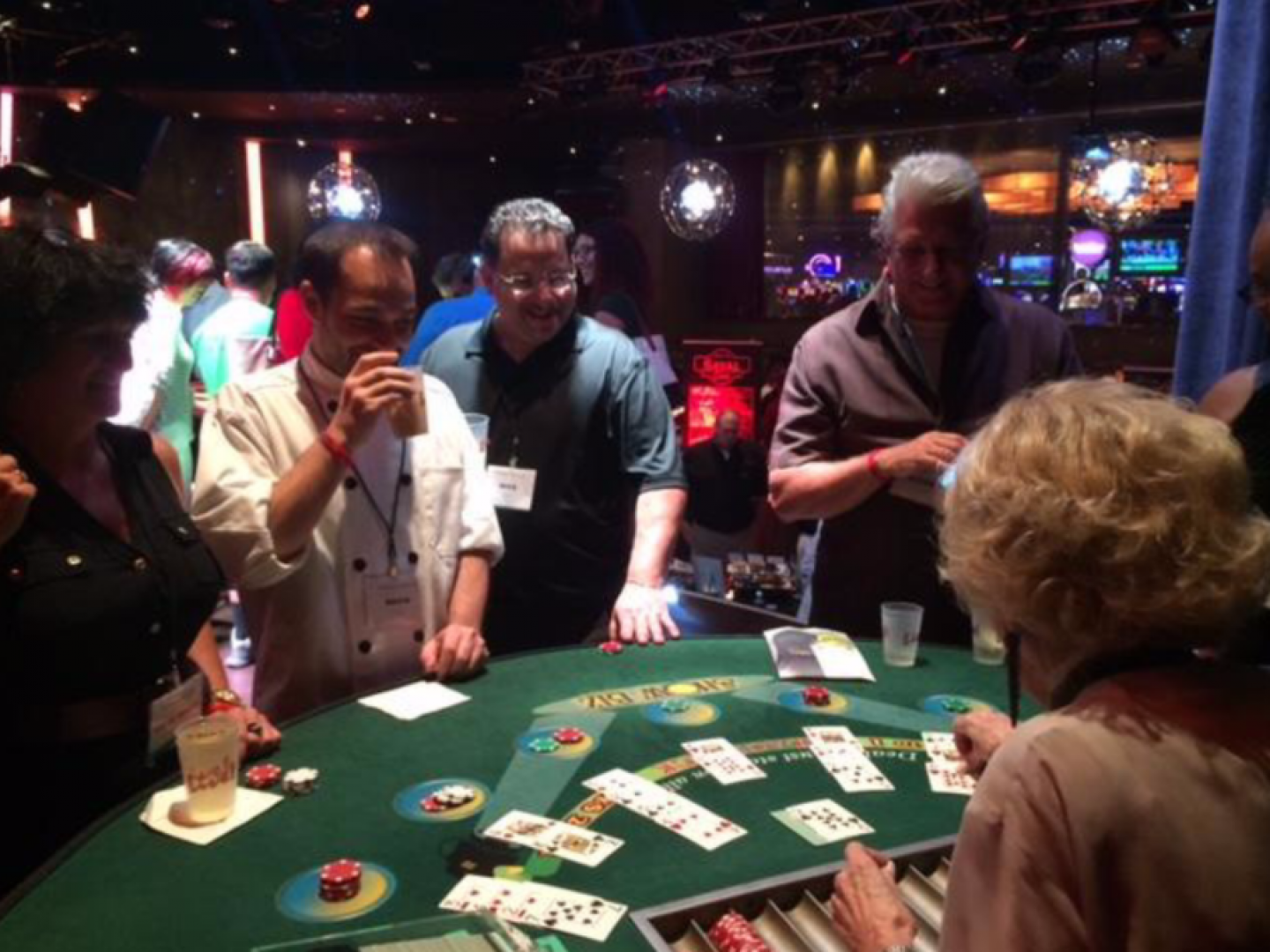 A group of people are playing a game of poker in a casino